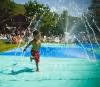 Child running through spray ground at Minerals Hotel